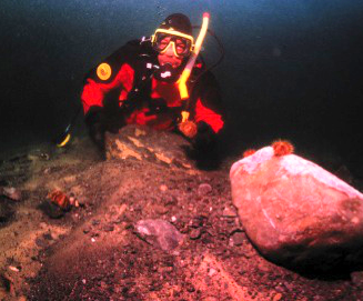 Scuba divers looking at undersea formation